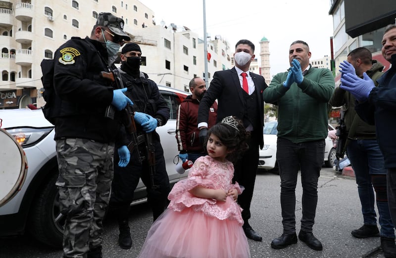 A Palestinian groom with a mask attends his wedding in the West Bank city of Hebron.  EPA
