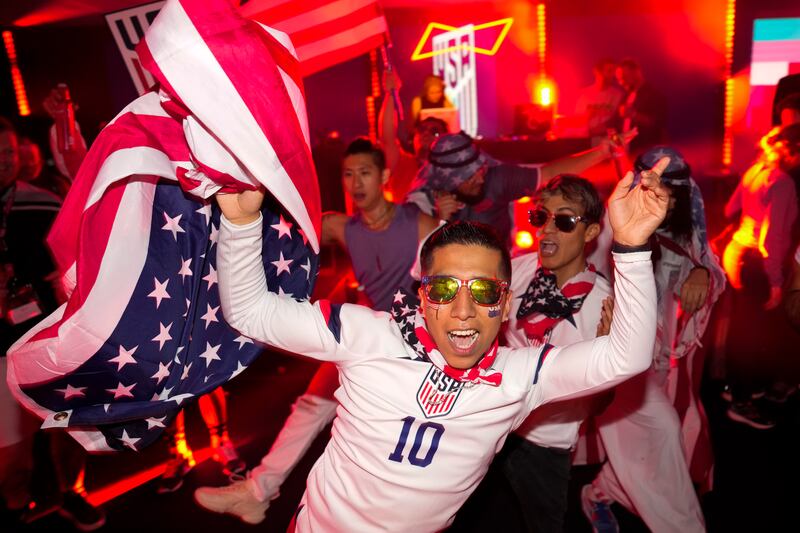 People dance at an official US football fan party at the Budweiser World Club in Doha. AP