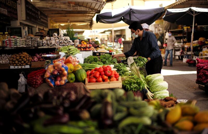A man purchases vegetables at a wholesale market in Manama, Bahrain. Reuters