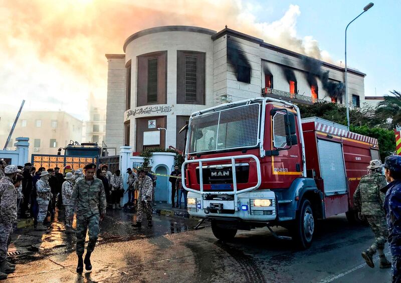 A firetruck and security officers at the scene of an attack outside the Libyan foreign ministry headquarters in the capital Tripoli. AFP