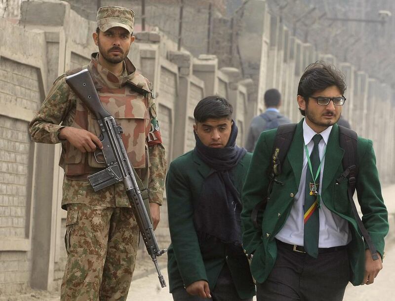 A soldier stands guards outside the Army Public School, in Peshawar, which was targeted by Taliban militants in December. Mohammad Sajjad / AP Photo