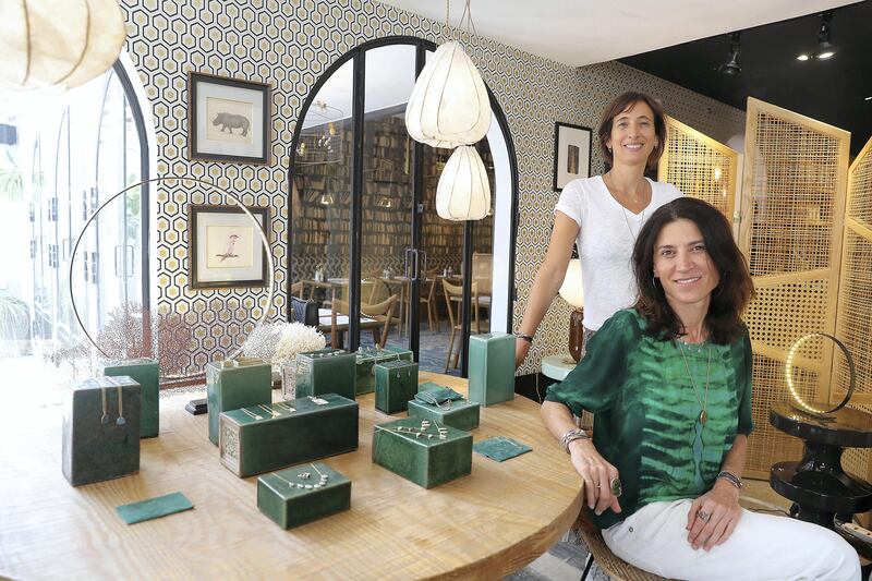 DUBAI , UNITED ARAB EMIRATES , SEP 19  ��� 2017 : - Emma Sawko , founder ( left in white ) and Mathilde Danglade , jewellery designer ( right in green ) with the new collection of jewellery which is on display at the Comptoir 102 on Jumeirah Beach Road in Dubai. ( Pawan Singh / The National ) Story by Hafsa Lodi