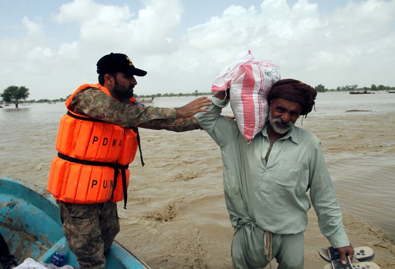 A man receives food, distributed by army troops in the flood-hit area of Rajanpur in Punjab, Pakistan, on August 27. AP