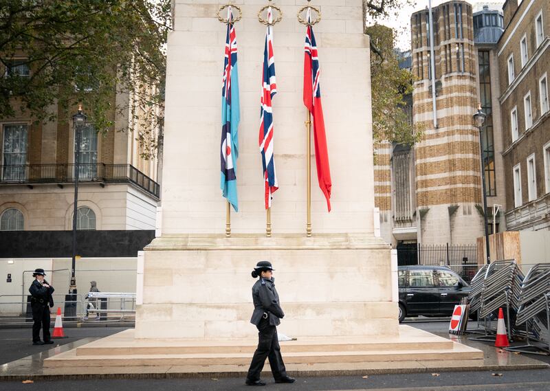 A Metropolitan Police officer on duty beside the Cenotaph in Whitehall, central London. PA