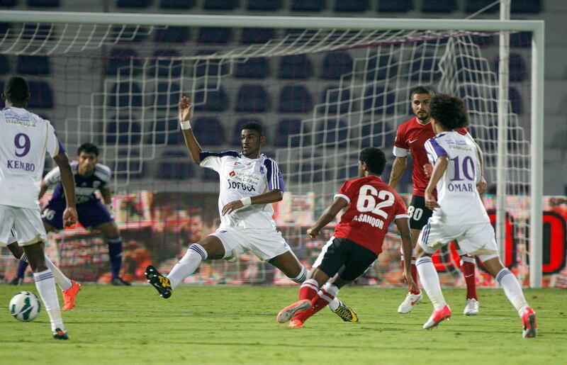 Al Ain, United Arab Emirates, Sept. 23 2012, Al Ain v Al Ahli- (centre red kit) Al Ahli's #62 Abdulaziz Sanqour shoots on goal.  Mike Young / The National