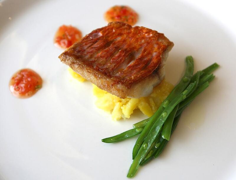 Pan fried red mullet with crushed saffron potato, French beans and tomato salsa dish (main course) in the Nineteen restaurant at Montgomerie Golf Club in Emaar's Emirates Hills in Dubai. Pawan Singh / The National