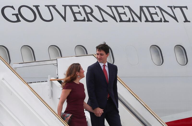 Canada's Prime Minister Justin Trudeau and wife Sophie Gregoire Trudeau chat as they leave their aeroplane. Reuters