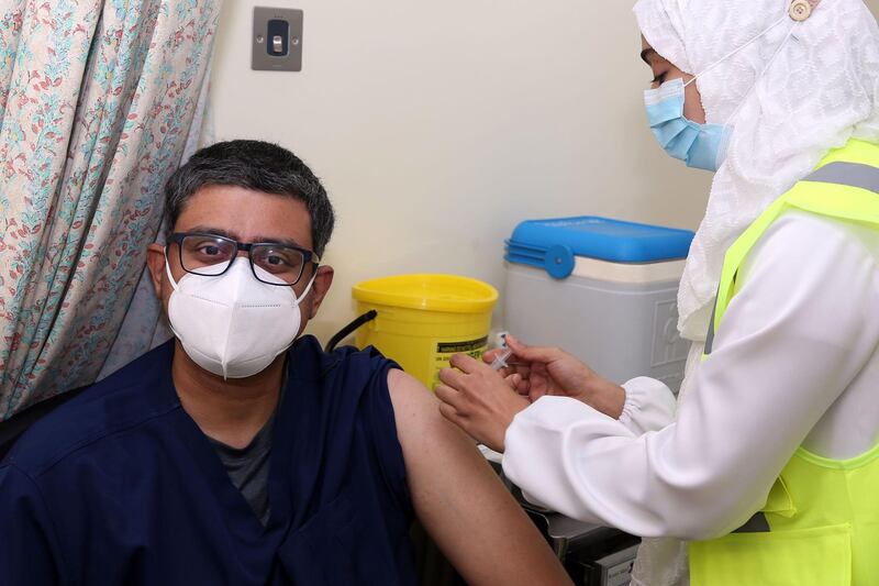 A doctor receives his first dose of the Pfizer-BioNTech Covid-19 vaccine in the Omani capital Muscat.  AFP