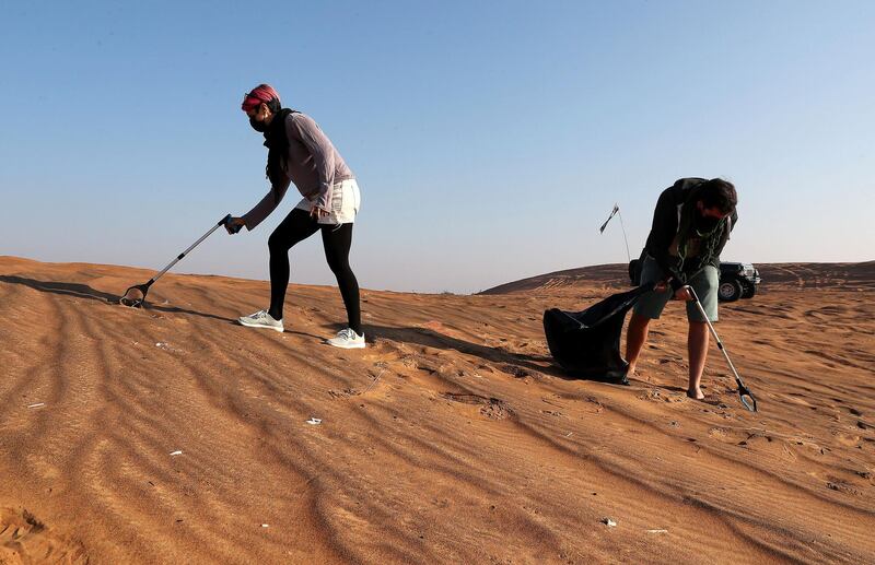 SHARJAH, UNITED ARAB EMIRATES , January 16– 2021 :- Members of the off roaders club collecting trash during the desert clean up drive at the Al Badayer desert area in Sharjah. (Pawan Singh / The National) For News/Stock/Online/Instagram/Standalone/Big Picture. Story by Nick Webster