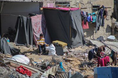 Displaced Palestinians construct makeshift shelters amid the rubble of destroyed homes in Khan Younis after fleeing from Rafah in the southern Gaza Strip. Bloomberg.
