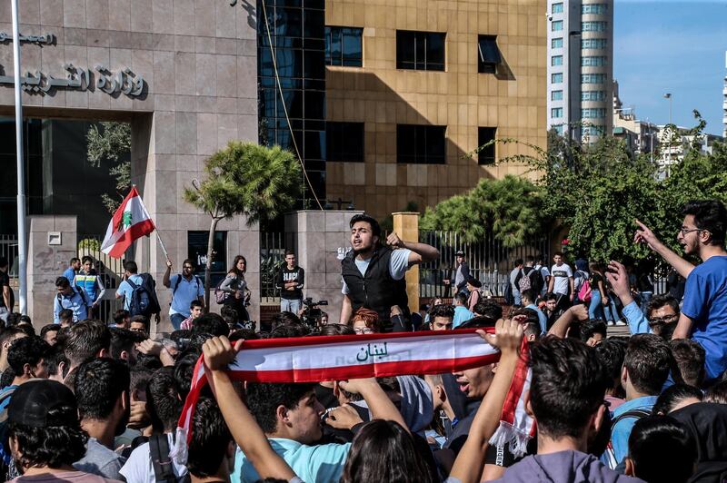 Lebanese students from various schools shout slogans and burn history books during ongoing anti-government protests in front the Education Ministry in Beirut, Lebanon 21 November 2019. EPA/NABIL MOUNZER