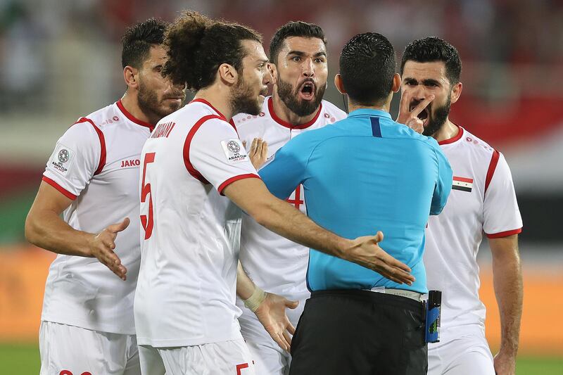 Syria players protests to referee Cesar Ramos of Mexico following Australia's second goal. Getty Images