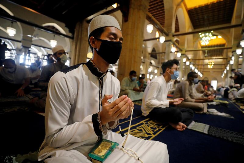 A Muslim wears a protective face mask while praying inside the Al Azhar mosque in Cairo. Reuters