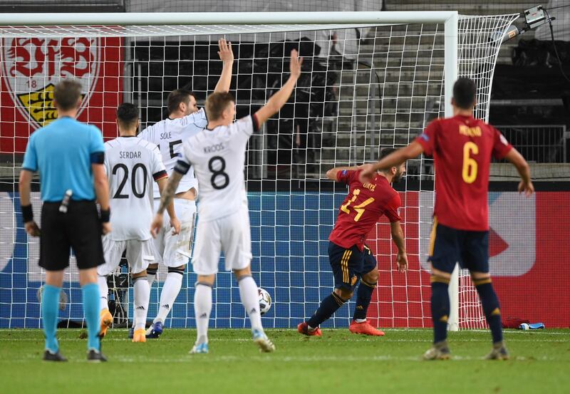 Germany players raise their arms after Jose Gaya scores Spain's equaliser. Getty Images