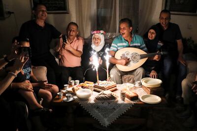 Palestinian grandmother Jihad Butto, 85, celebrates obtaining a bachelor's degree in religious studies with her family at her home in Nazareth, Israel, on October 9. Reuters