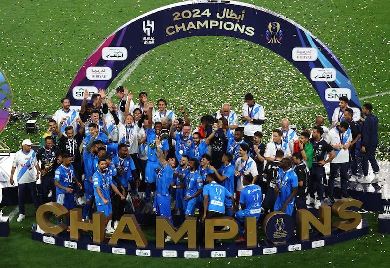 Al Hilal players celebrate with the trophy after winning the Saudi Super Cup. Reuters 