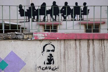 A graffiti reading in Arabic 'Where's my killer?' and depicting renowned Iraqi anti-government activist Ihab Al Wazni, who was shot dead in an ambush earlier this month, in the city of Karbala, A picture taken on May 23, 2021 shows a. AFP