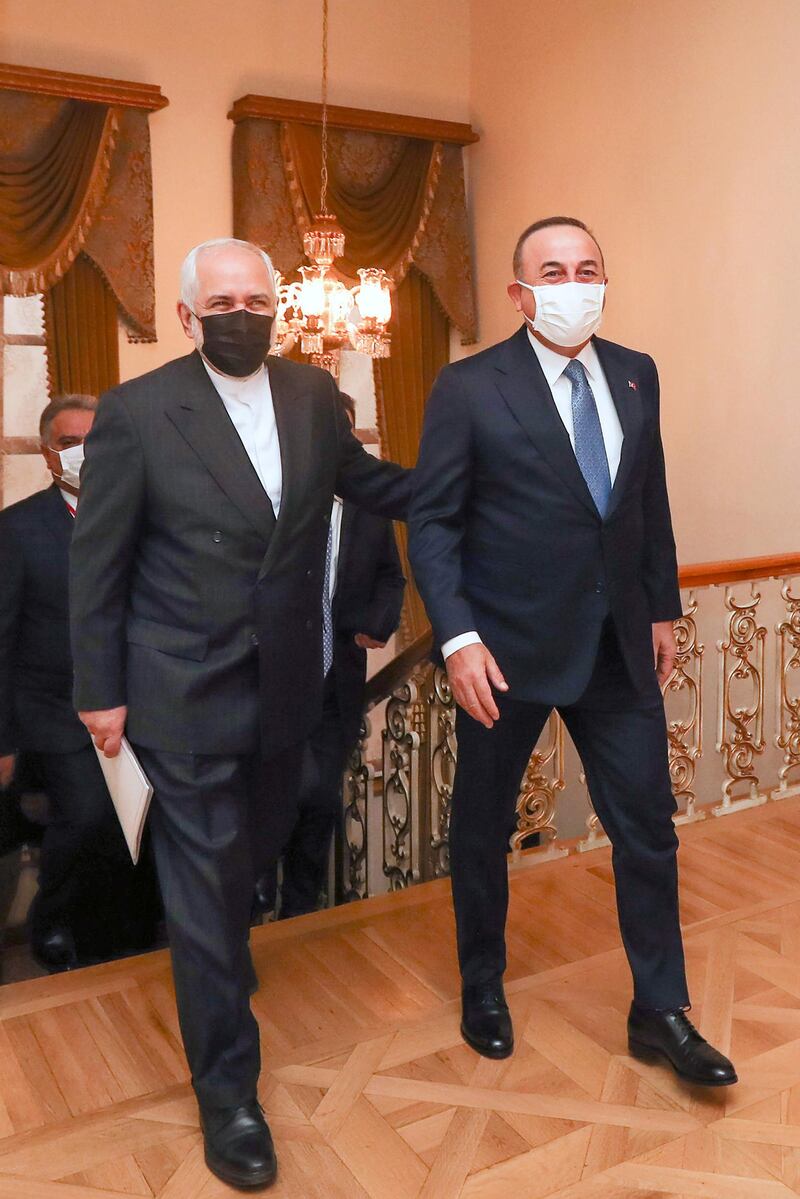 This handout picture taken and released by Turkish Foreign Minister Press Office on January 29, 2021 shows Turkish Foreign Minister Mevlut Cavusoglu (R) and his Iranian counterpart Javad Zarif (2L) walking before attending a meeting at the Dolmabahce Palace in Istanbul. RESTRICTED TO EDITORIAL USE - MANDATORY CREDIT "AFP PHOTO /Turkish Foreign Minister Press Office" - NO MARKETING - NO ADVERTISING CAMPAIGNS - DISTRIBUTED AS A SERVICE TO CLIENTS
 / AFP / Turkish Foreign Minister Press Office / Cem OZDEL / RESTRICTED TO EDITORIAL USE - MANDATORY CREDIT "AFP PHOTO /Turkish Foreign Minister Press Office" - NO MARKETING - NO ADVERTISING CAMPAIGNS - DISTRIBUTED AS A SERVICE TO CLIENTS
