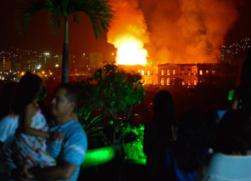 People watch as a massive fire engulfs the National Museum in Rio de Janeiro. AFP