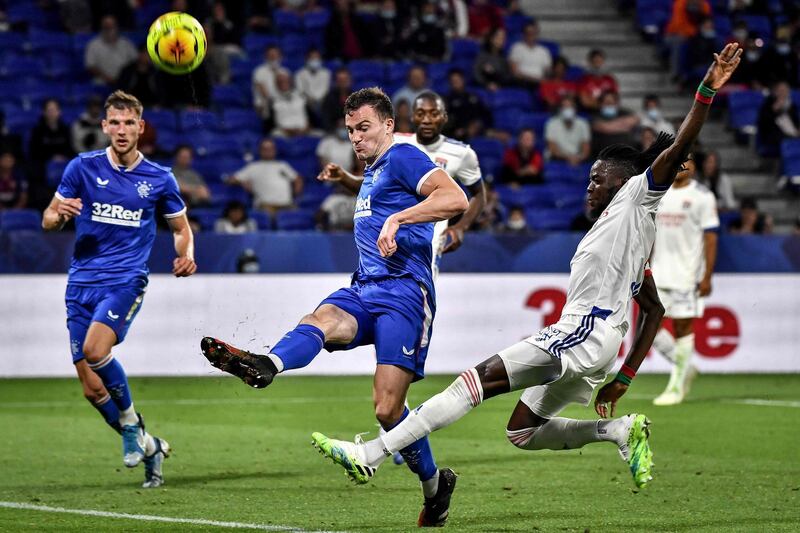 Rangers FC's George Edmundson, left, vies with Lyon's Bertrand Traore at the Groupama Stadium. AFP