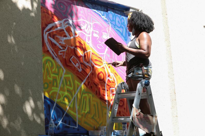 Sonia Jones, curated by Paints Institute, paints a mural on the boarded-up windows of St. John's Church as a work of art activism for racial justice at Black Lives Matter Plaza in Washington, U.S. REUTERS