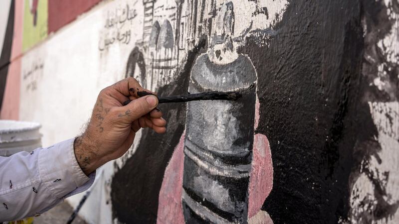 Mustafa Abd painting one of his artworks in Al Sadoon tunnel next to Baghdad's Tahrir square preparing for the anniversary of the protests. Haider Husseini for The National