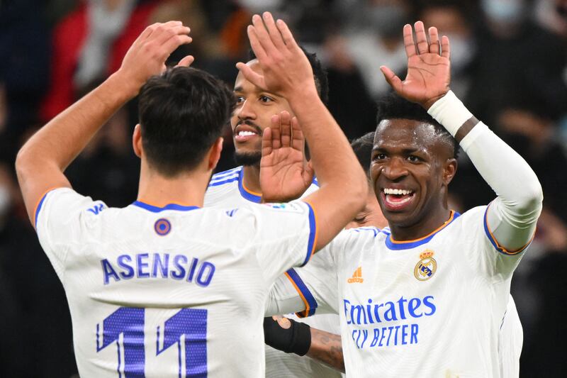 Real Madrid's Brazilian forward Vinicius Junior (R) celebrates scoring his team's third goal during the Spanish league football match between Real Madrid CF and Valencia CF at the Santiago Bernabeu stadium in Madrid on January 8, 2022.  (Photo by GABRIEL BOUYS  /  AFP)