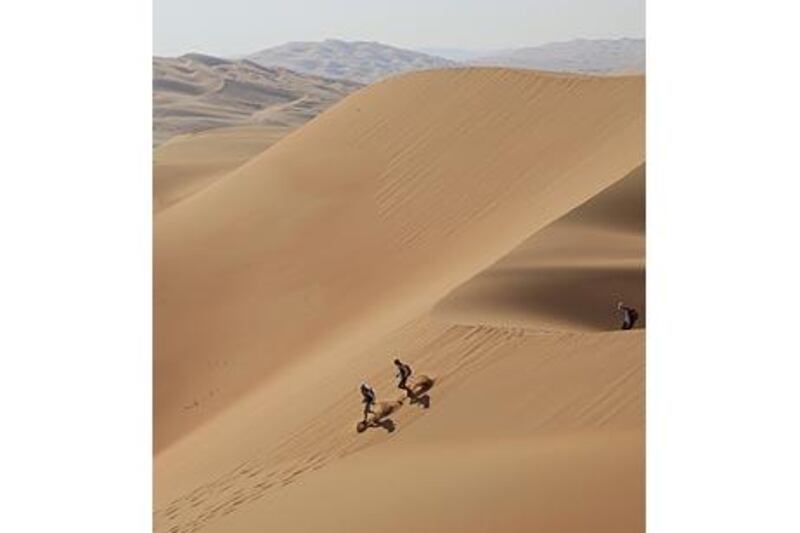 Competitors run down a sand dune during last year's Abu Dhabi Adventure Challenge.