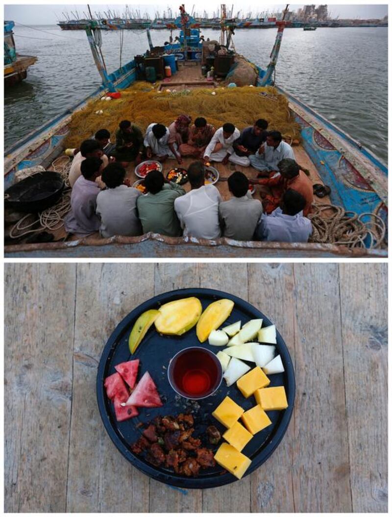 Haji Husain, 65, a fisherman, sitting with colleagues to eat iftar on a fishing boat in Ibrahim Hyderi, on the outskirts of Karachi, Pakistan on June 12, 2016. Husain says: “For me Ramadan is to fast and do good deeds, it keeps you away from Satan.” Photo by Akhtar Soomro