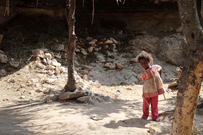 A child stands outside a cave where a Yemeni family has sought refuge due to poverty and lack of housing, west of the suburbs of Yemen's third-city of Taez on December 2. AFP