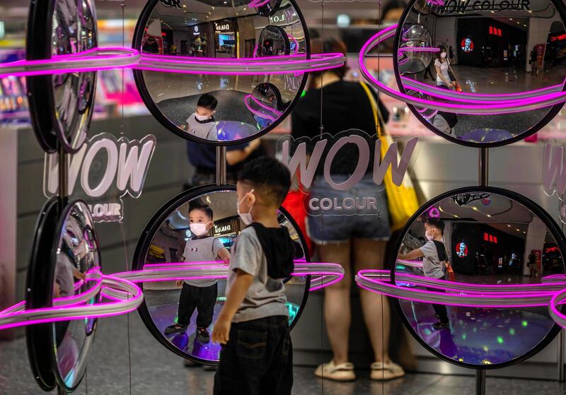 A boy wearing a mask looks at himself in the shop mirrors in Guangzhou, Guangdong province, China. China reported 17 new confirmed Covid-19 cases on May 10 , seven of which were reportedly linked to Inner Mongolia Autonomous Region, according to National Health Commission of China. EPA