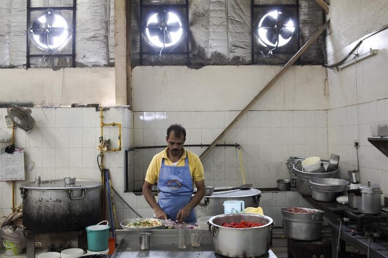 The Al Quoz area of Dubai has become a mix of industrial businesses and cultural destinations of all sorts. Abdul Rahman prepares food inside Noor Al Quoz Popular Kitchen. Lee Hoagland / The National