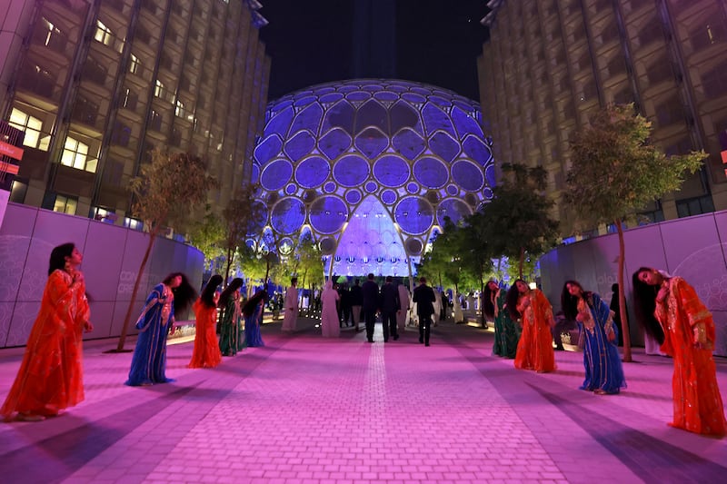 Performers line up to welcome visitors to the site of Expo 2020 Dubai. Photo: AFP