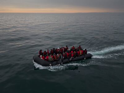 A boat carrying around 50 migrants drifts into English waters after being trailed by a French emergency tug, the Abeille Normandie, from the French coastline in August. Getty Images 