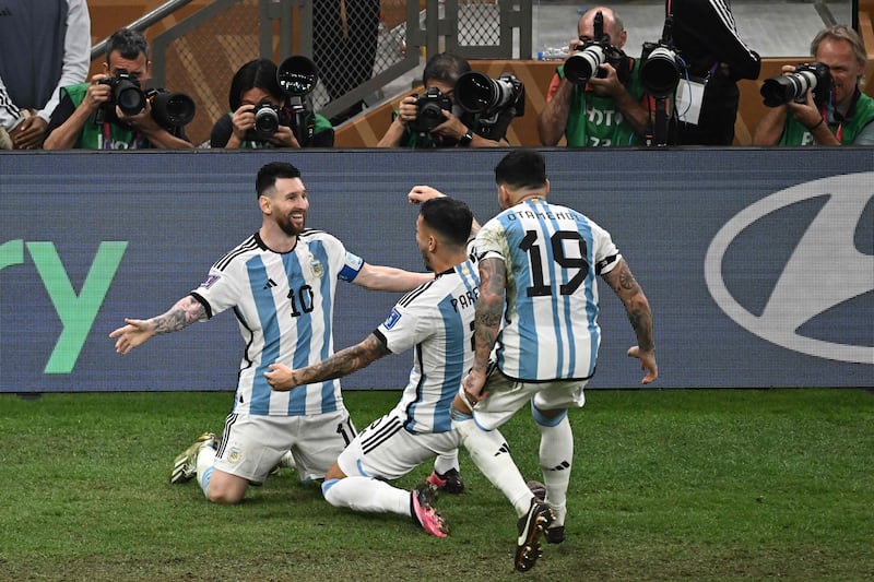 Lionel Messi celebrates with teammates after scoring Argentina's third. AFP
