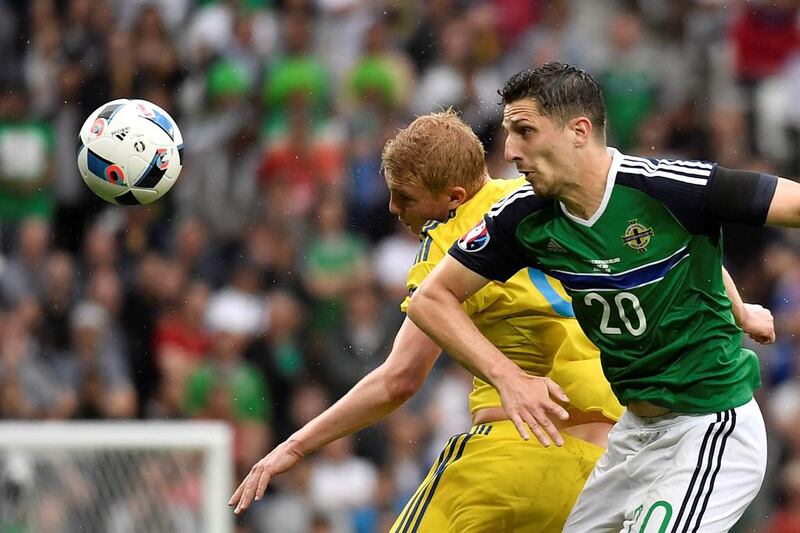 Ukraine midfielder Viktor Kovalenko, left, vies for the ball with Northern Ireland defender Craig Cathcart. Jeff Pachoud / AFP