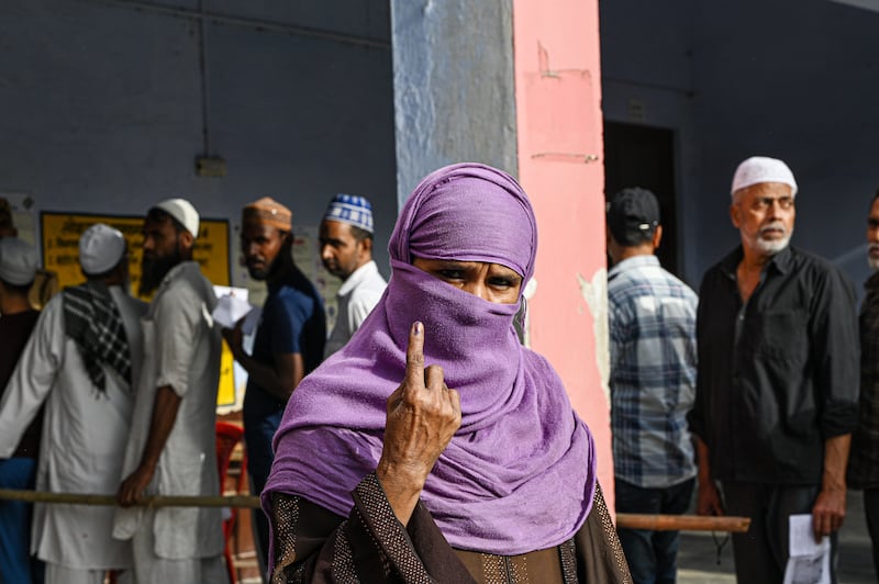 A voter shows her ink-marked finger outside a polling station in Muzaffarnagar, Uttar Pradesh. Bloomberg