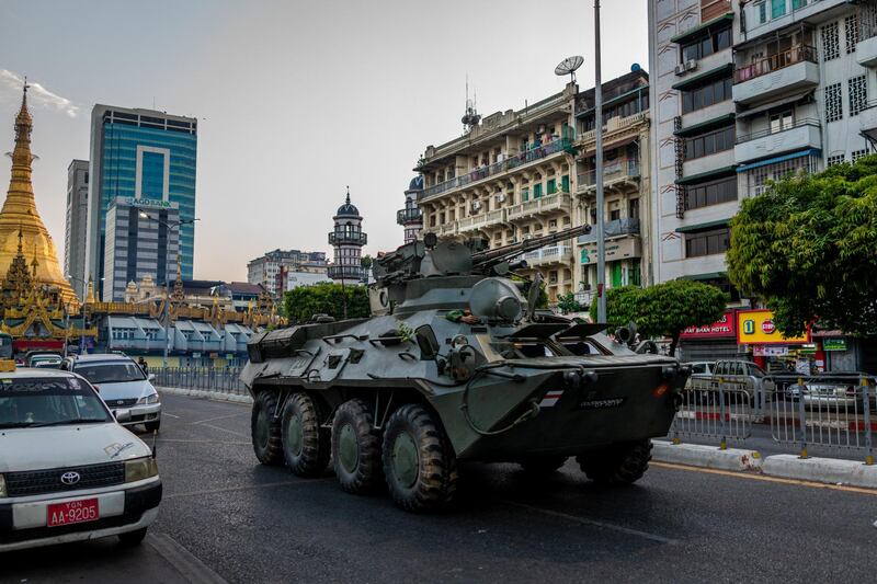 A military armored vehicle is seen driving along with traffic on a road in Yangon, Myanmar. Getty