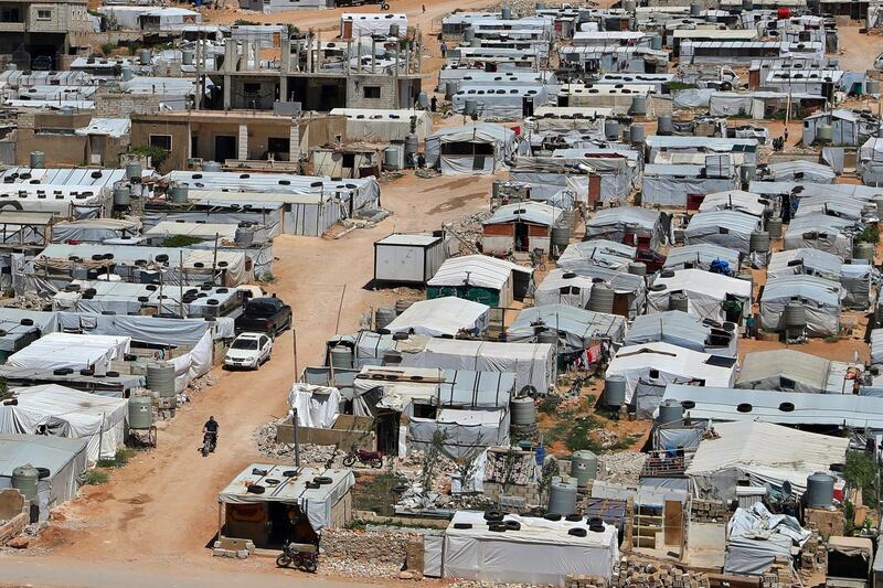 This Sunday, June 16, 2019 photo, shows a Syrian refugee riding a motorcycle among tents at a refugee camp in the eastern Lebanese border town of Arsal, Lebanon. Authorities in Lebanon are waging their most aggressive campaign yet against Syrian refugees, making heated calls for them to go back to their country and taking action to ensure they canâ€™t put down roots. They are shutting down shops where Syrians work without permits and ordering the demolition of anything in their squalid camps that could be a permanent home. (AP Photo/Bilal Hussein)