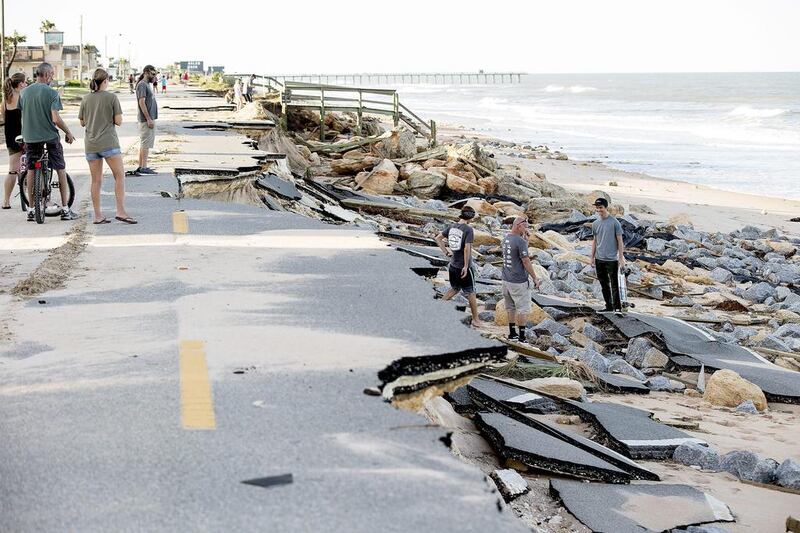 Beach goers check out damage left by Hurricane Mathew having washed away part of the historic State Road A1A in Flagler County, Florida. Hurricane Matthew hit the Florida coast leaving four dead and thousands without power, media reported. EPA