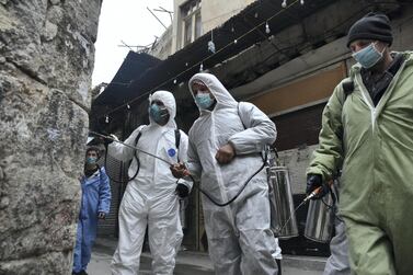 Workers at the Syrian municipality department sterilise streets in Damascus on December 29, 2020. The campaign is part of the government’s efforts to prevent further spreading of Covid-19. EPA