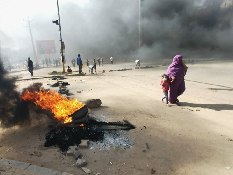 Protesters burnt tyres to block a road in Khartoum.