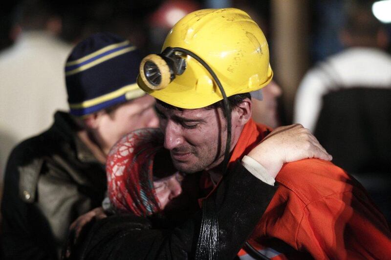 A miner hugs a relative in front of a coal mine site in Soma. An explosion and fire in the coal mine in Soma killed at least 200 miners and trapped hundreds more. Osman Orsal / Reuters