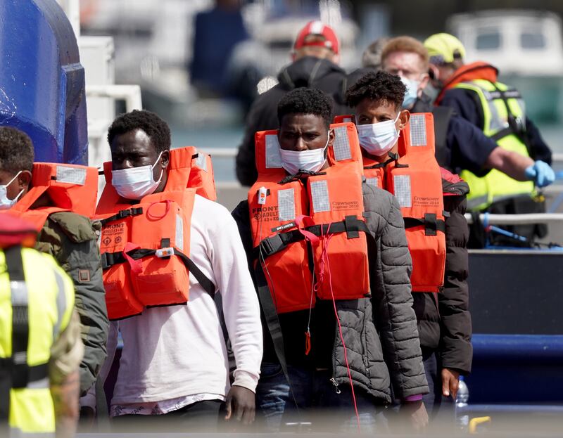 A group of people thought to be migrants are brought in to Dover, UK, on Tuesday after being found on a small boat in the Channel. PA