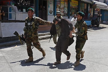 Afghan Army soldiers walk with a captured suspected militant following an attack on the national television station in Jalalabad on May 17, 2017. EPA