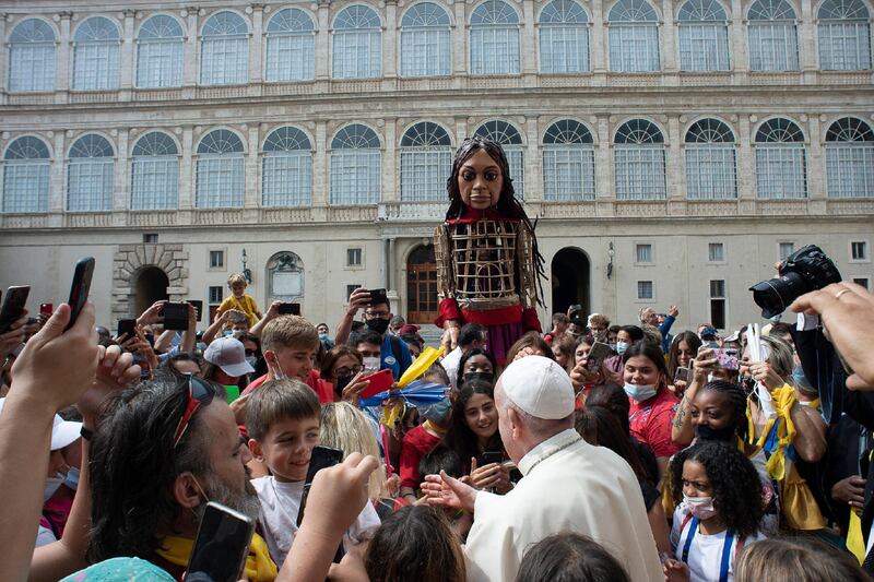 Pope Francis receives in audience the children participating in the 'Open Hospitality March' at the Vatican, along with Little Amal, a 3.5 metre tall puppet of a young Syrian refugee girl. EPA