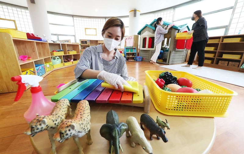 Teachers disinfect toys at a kindergarten in South Korea. EPA