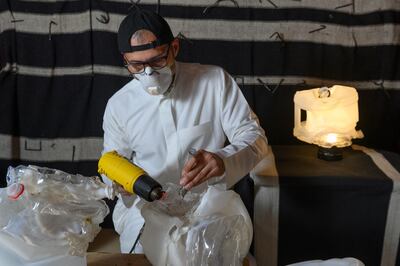 Artist Sultan bin Fahad works on one of the bottles that form his audio installation ‘Al Hida'a’ (2019). Courtesy the artist