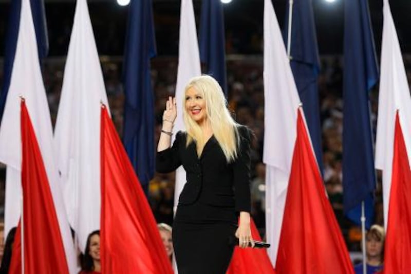 Christina Aguilera waves after singing the National Anthem prior to the NFL's Super Bowl XLV football game in Arlington, Texas, February 6, 2011. The Pittsburgh Steelers will play the Green Bay Packers in today's game.    REUTERS/Jeff Haynes (UNITED STATES - Tags: SPORT FOOTBALL ENTERTAINMENT) *** Local Caption ***  SBP521_NFL-SUPERBOW_0206_11.JPG