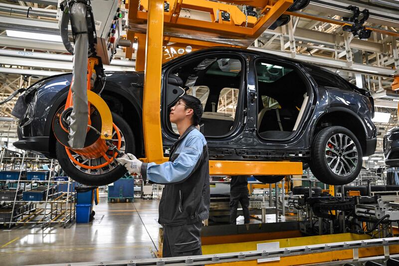A Nio assembly line in Hefei, China. A weakening economic outlook and price cuts have dimmed the outlook for China's electric vehicle sector. AFP